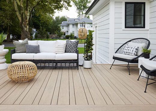 A house with a large deck and stairs leading up to it.