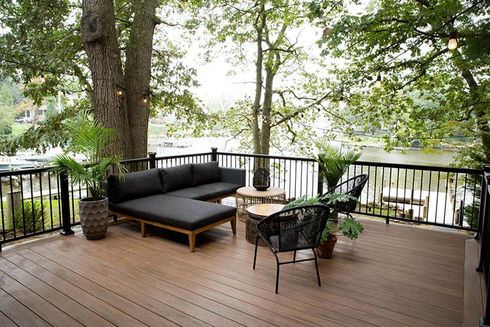 A house with a large deck and stairs leading up to it.