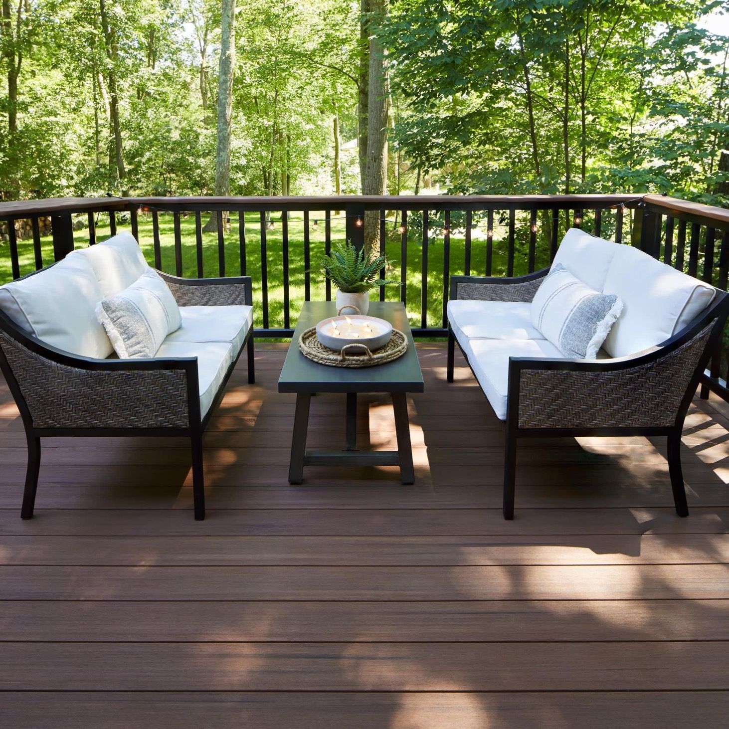 A house with a screened in porch and a large deck.