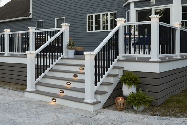 A screened in porch with chairs and a table with candles on it