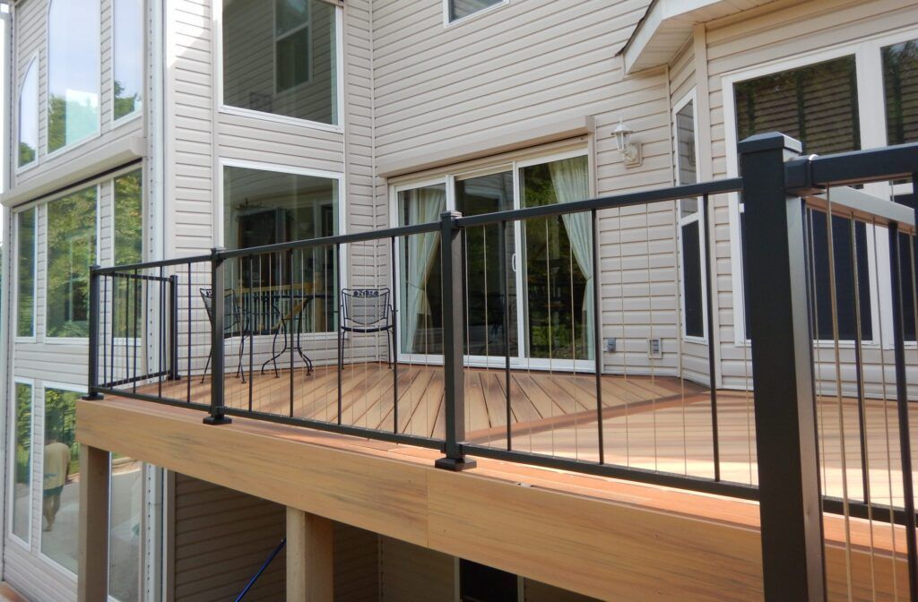 A wooden deck with furniture and a vase on it
