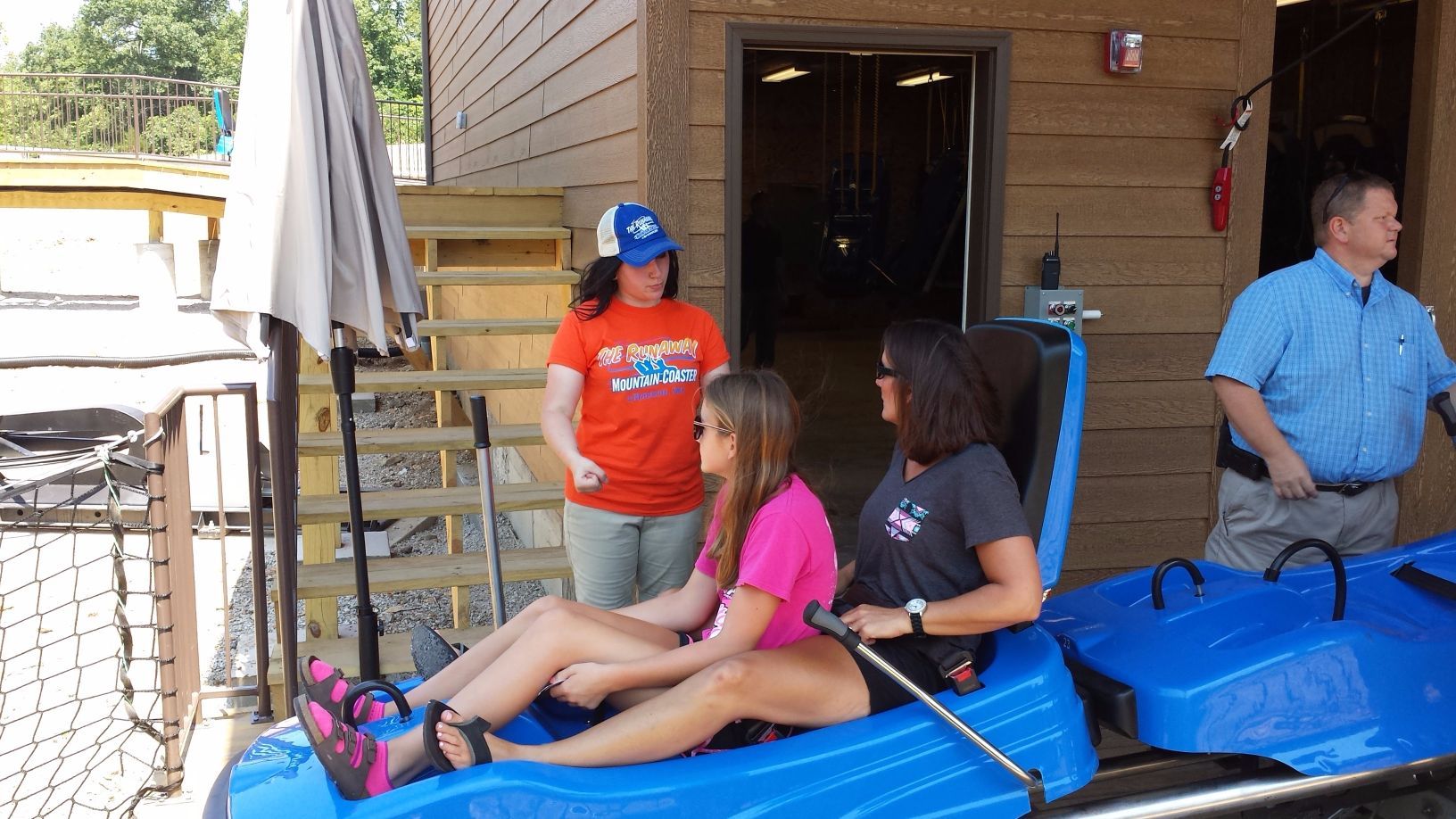 Woman talking to two girls while riding the coaster