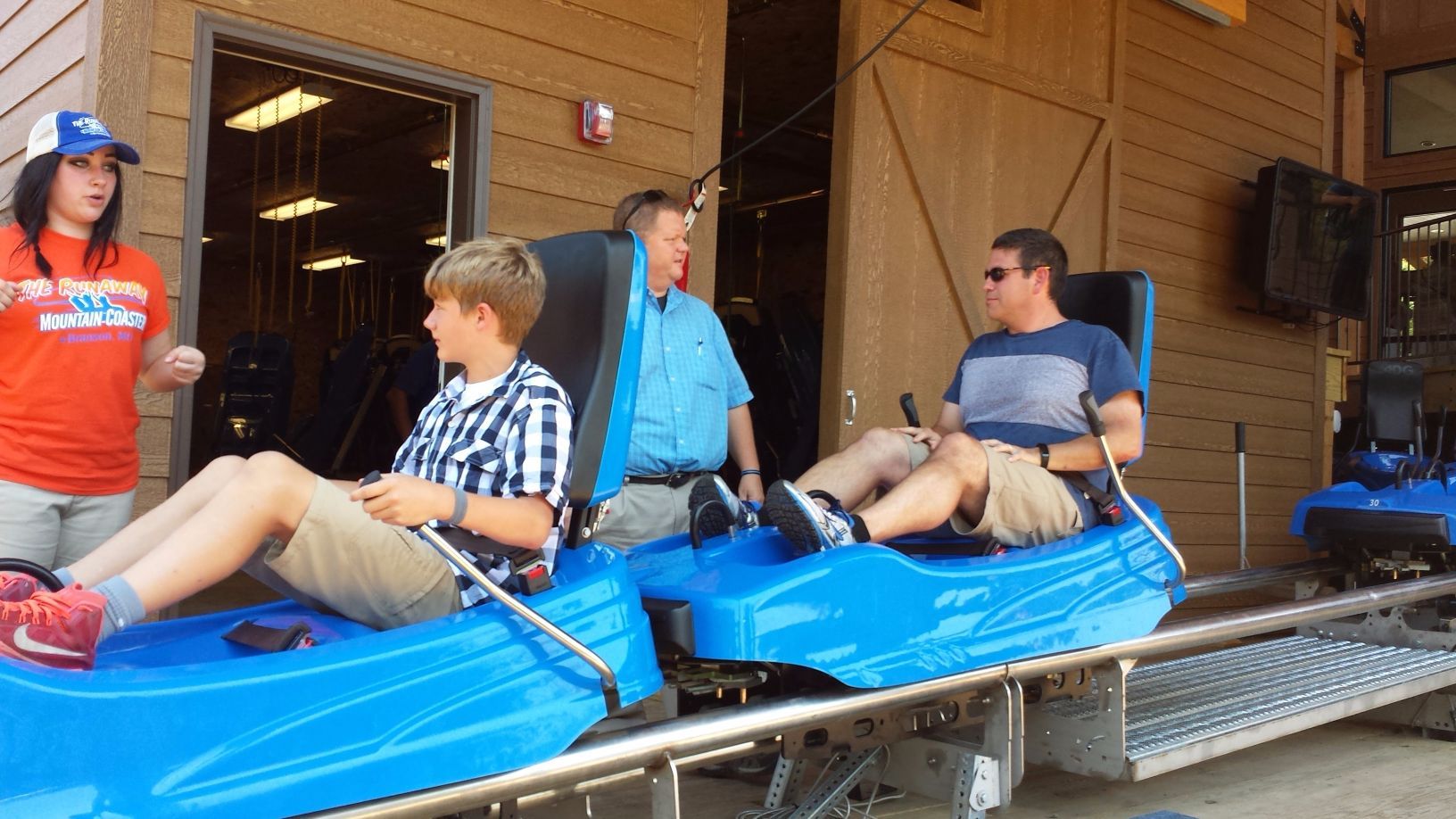 a family getting ready to ride the mountain coaster