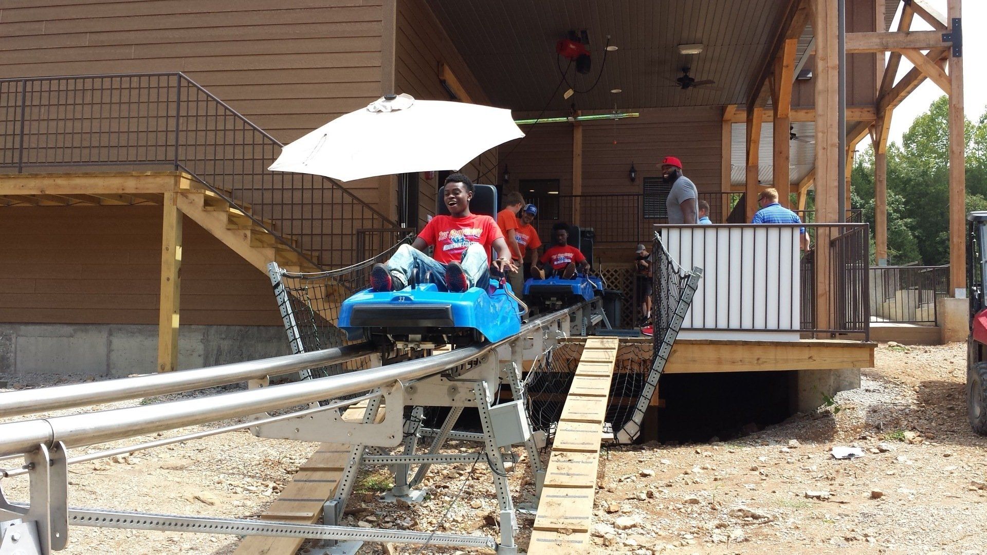 People with red shirt riding in coaster