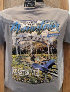 Close-up of a souvenir t-shirt featuring a mountain coaster design