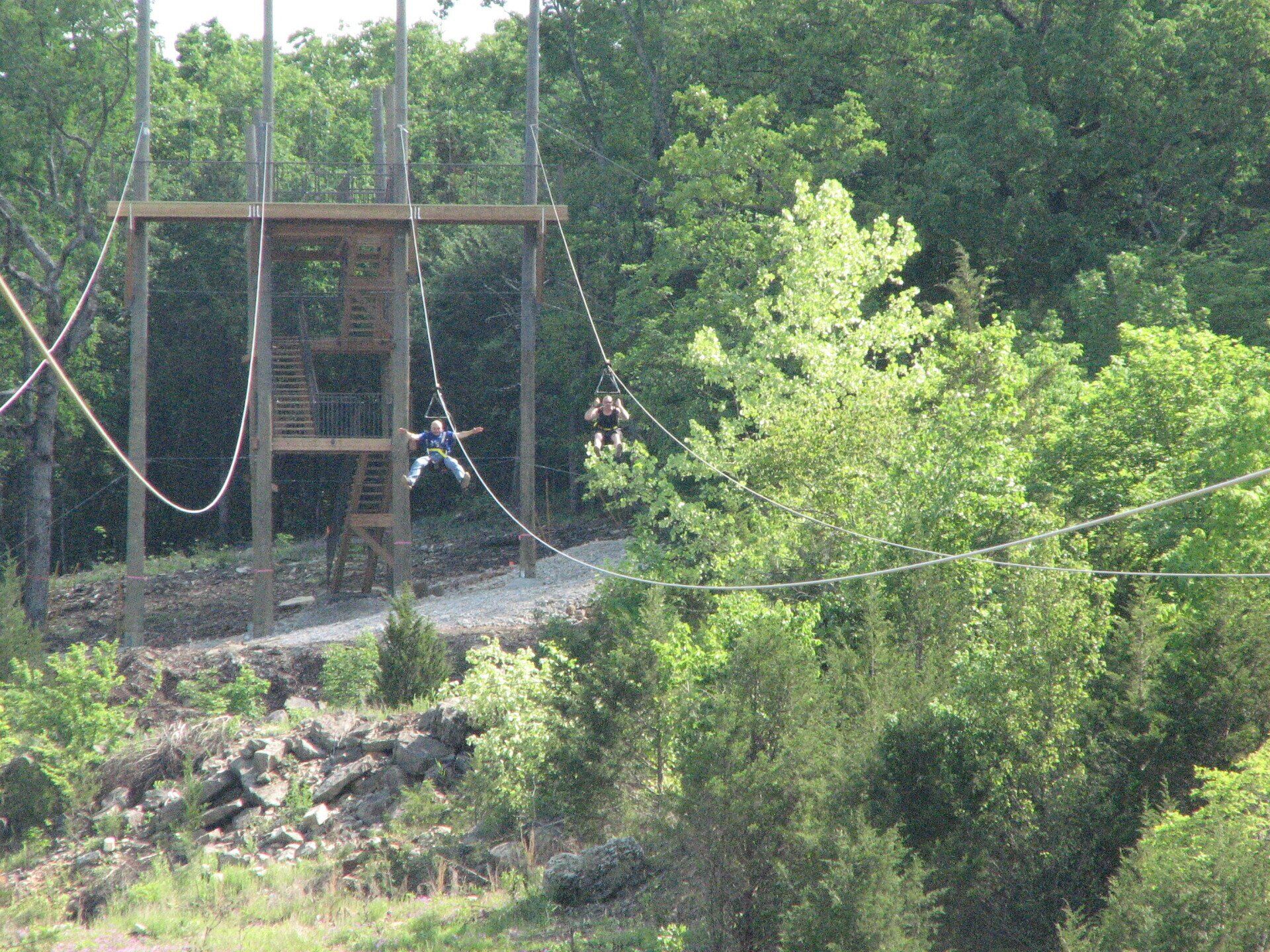 Far view of two people at the zipline