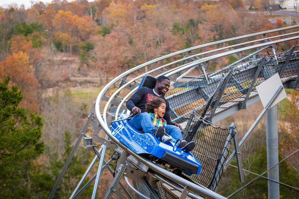 A child enjoying riding the Branson Runaway Mountain Coaster with parent