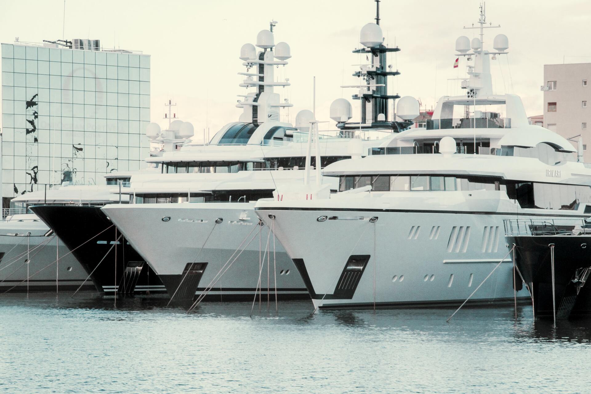 Large luxury yachts docked in an urban marina