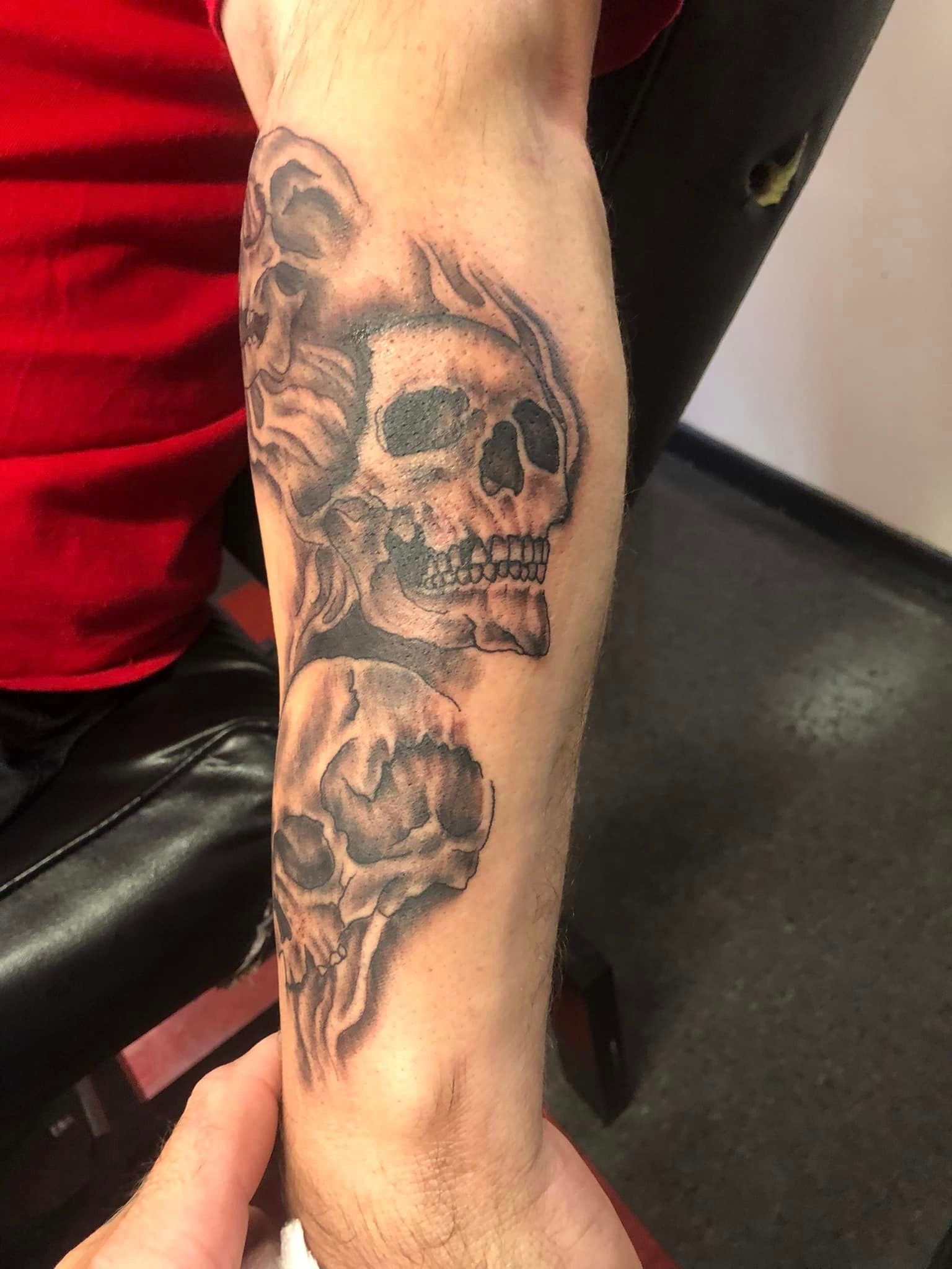 3 skulls arm tattoo 2