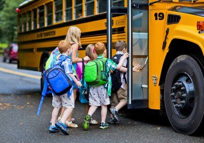 A group of children are getting on a school bus.