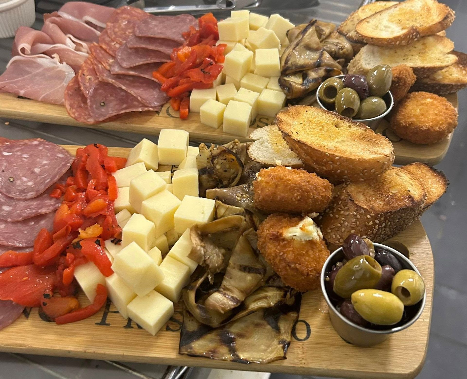 A wooden cutting board filled with lots of different types of food.