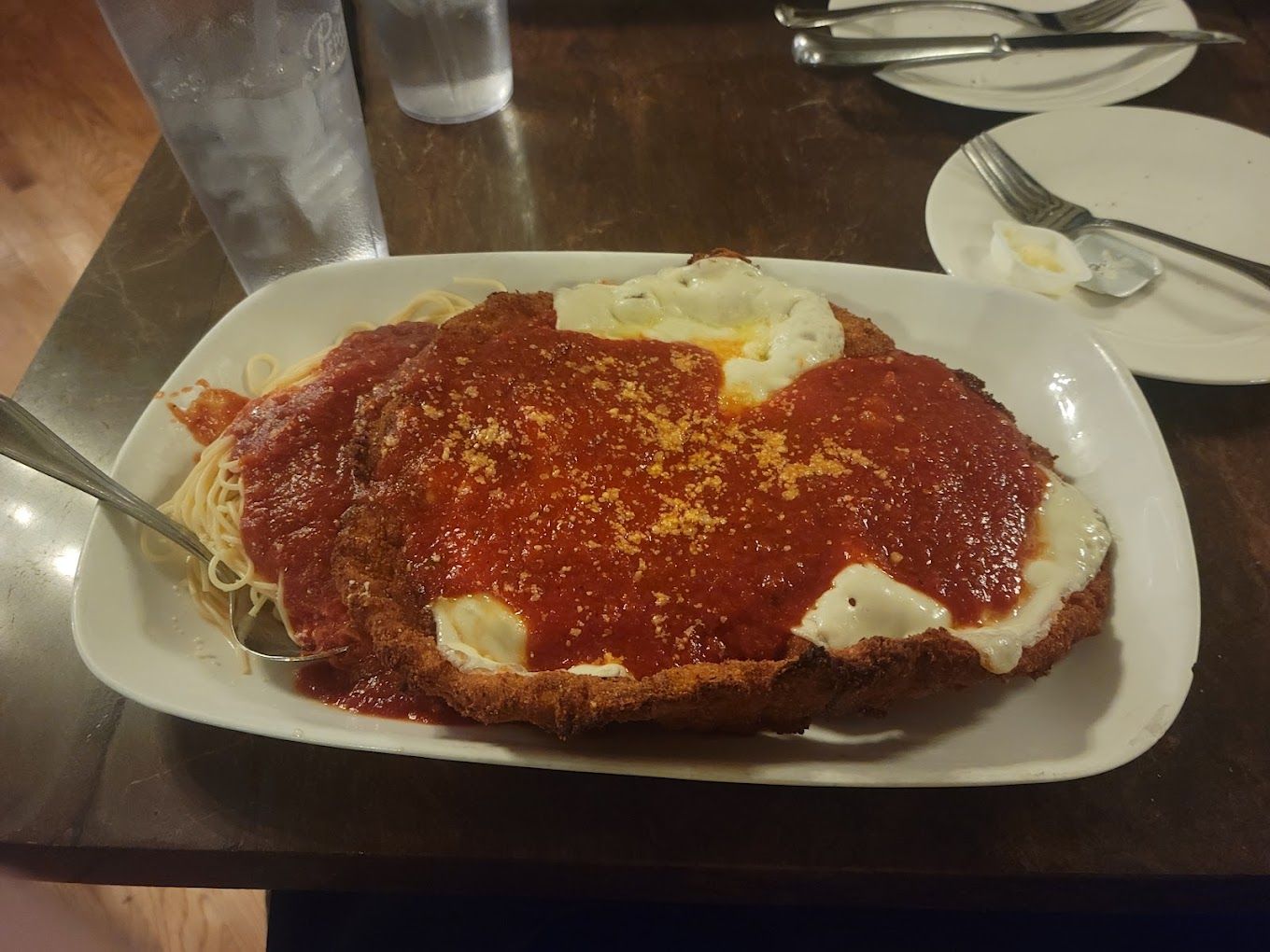 A plate of food with spaghetti and sauce on a table