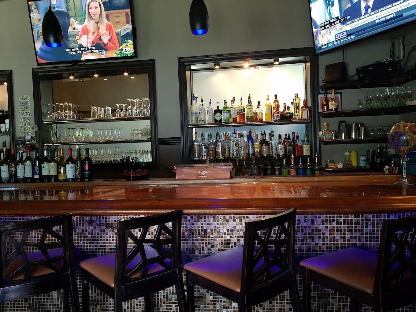 A bar with a lot of bottles of liquor on it