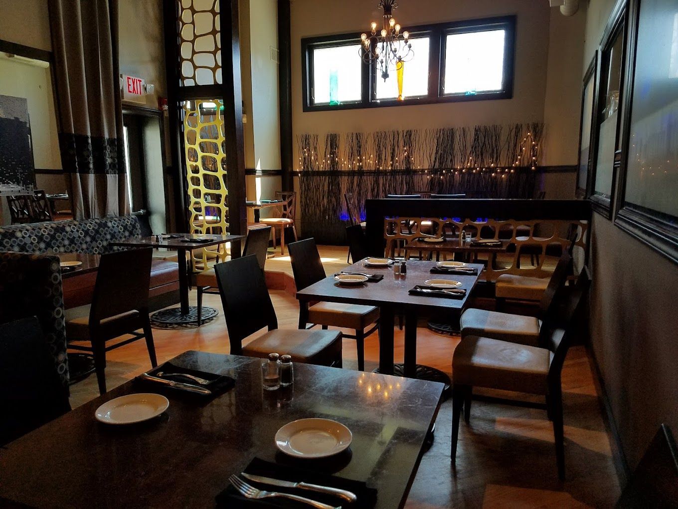 A restaurant filled with tables and chairs with plates on them