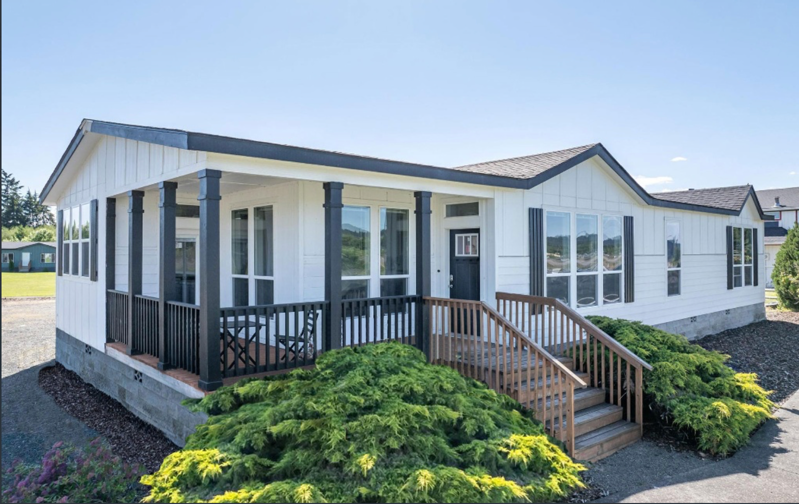 A bedroom with a large bed and a ceiling fan