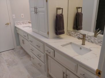 A bathroom with two sinks and a mirror.