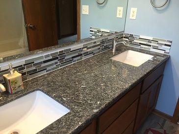 A bathroom with a sink and a mirror.