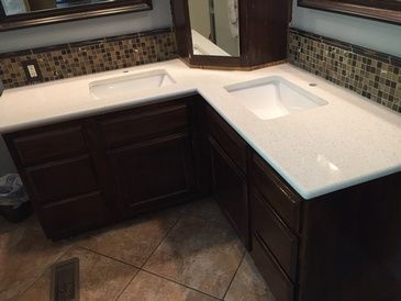 A bathroom with two sinks and a mirror.