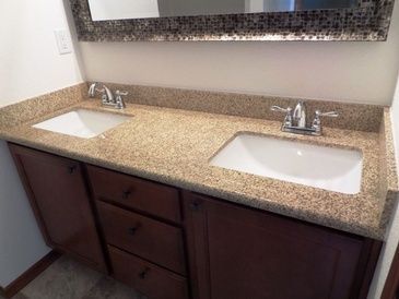 A bathroom with two sinks and a mirror.