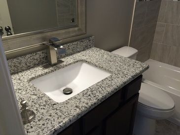A bathroom with a sink , toilet , and bathtub.