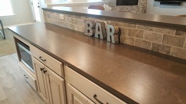 A kitchen counter with a sign that says bar on it.