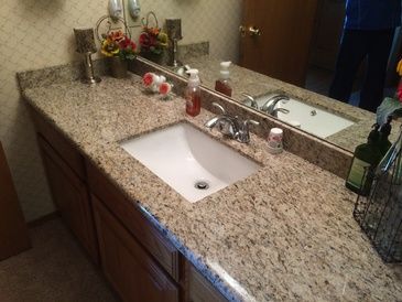 A bathroom with two sinks and a large mirror.