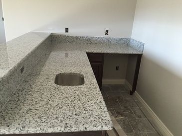 A kitchen with granite counter tops and a sink