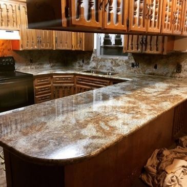 A kitchen with granite counter tops and wooden cabinets