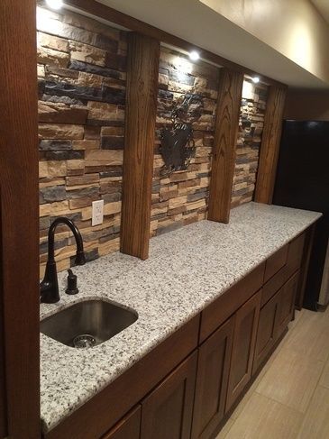 A kitchen with granite counter tops and a sink.