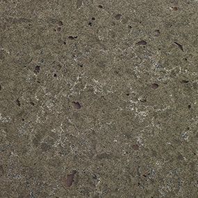 A close up of a concrete surface with a lot of small holes in it.