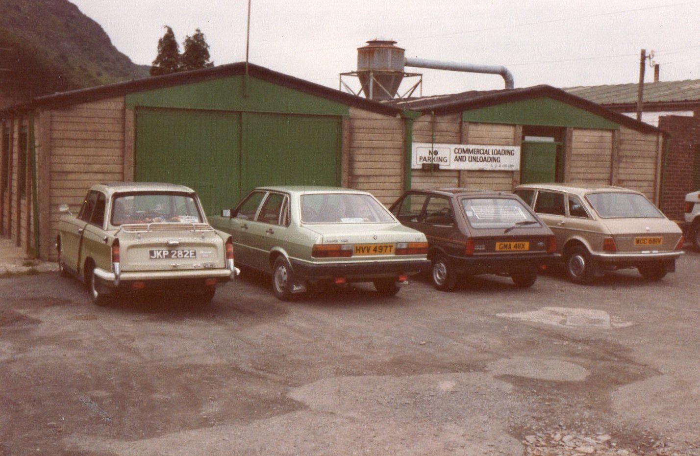 Staff cars parked outside Quaeck's workshop