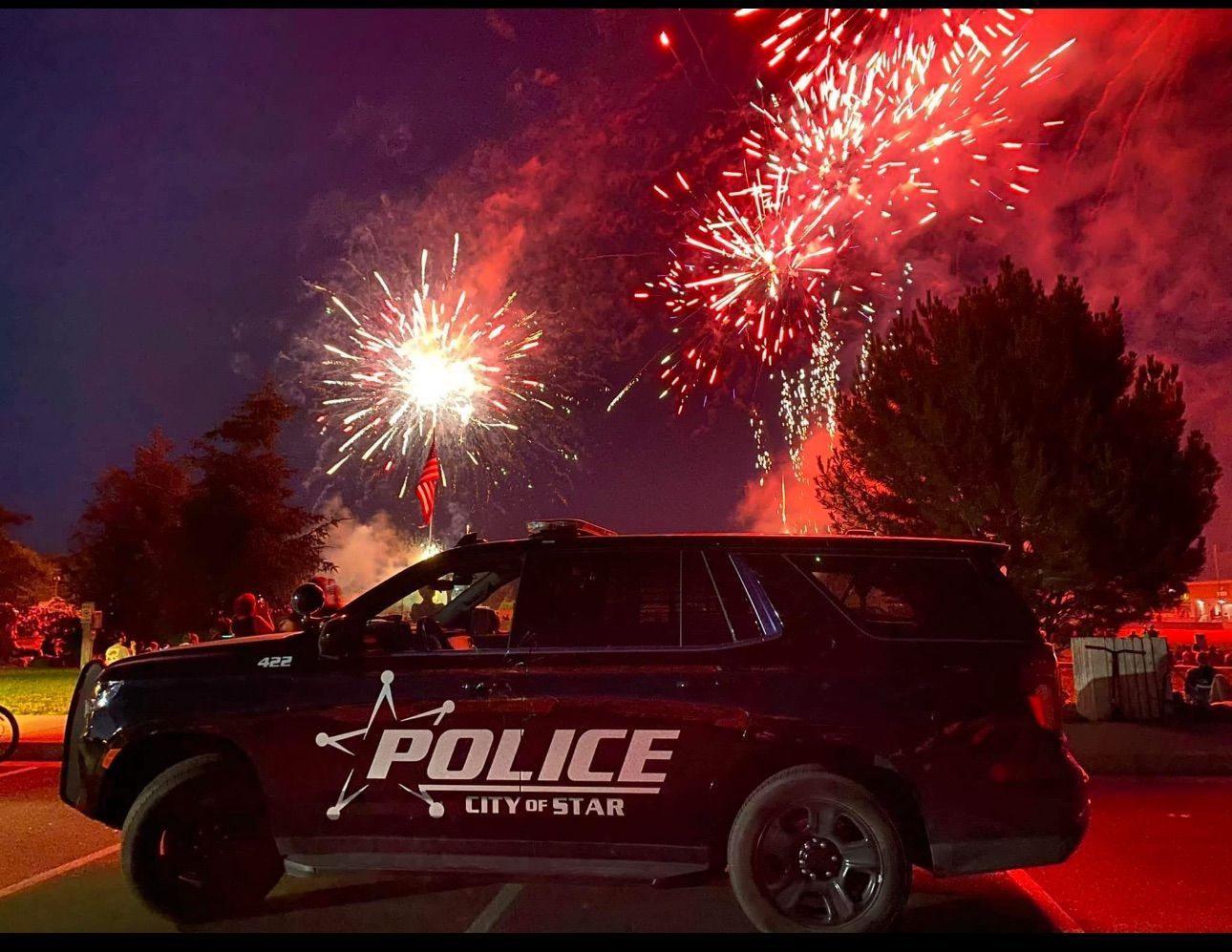 Star, Idaho police car with fireworks behind it
