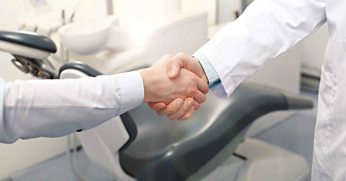 Business men shaking hands | Buying and selling dental businesses in AL FL GA and NC