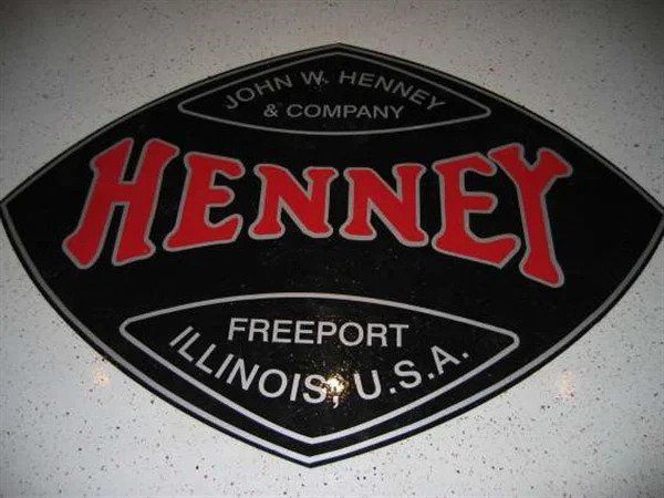 Black Henney sign with red text, featuring