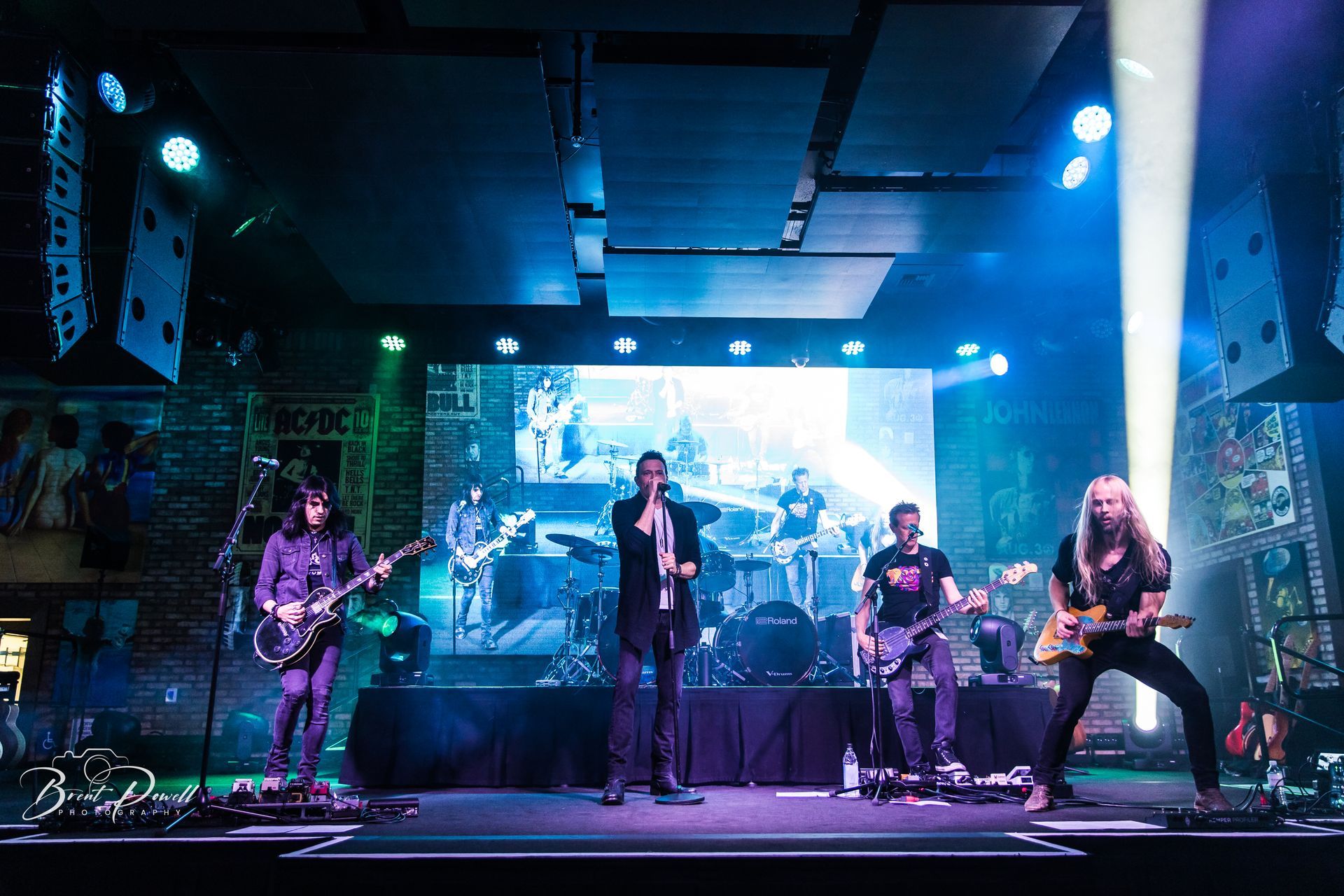 A group of people are standing on a stage playing instruments.