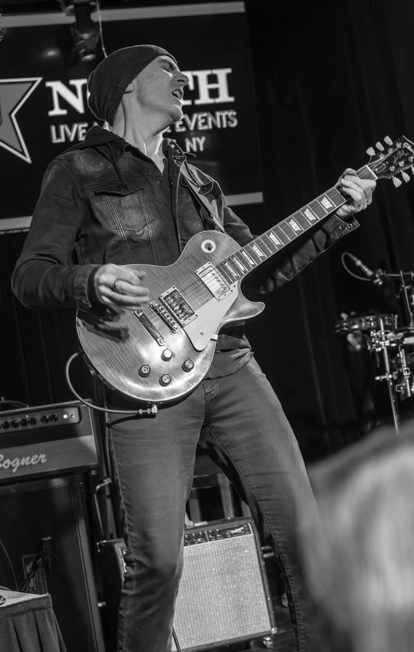 Guitarist playing electric guitar on stage at North Live Events in NY.