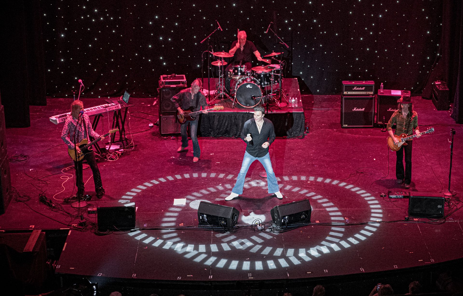 A group of men are playing instruments on a stage.