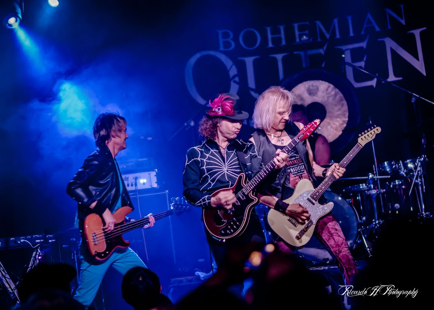 A group of people are playing guitars on a stage.