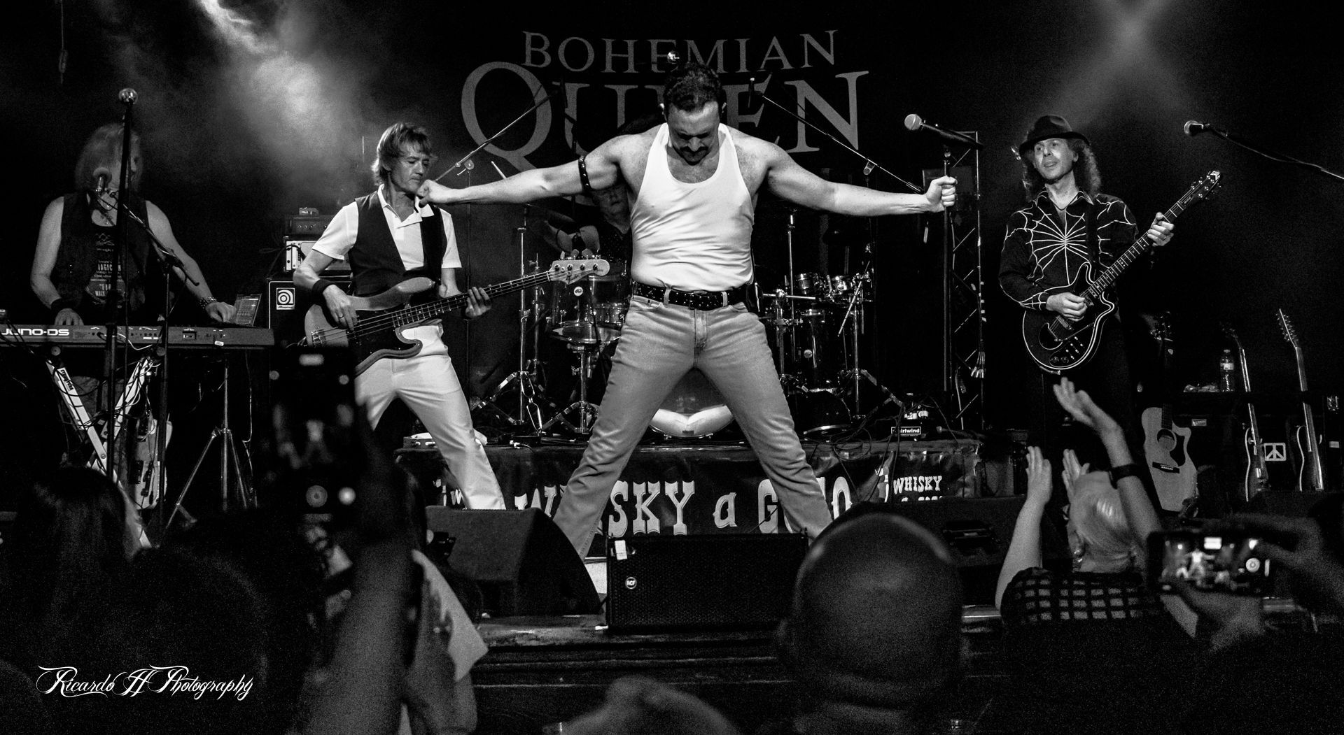 A black and white photo of bohemian queen performing on stage