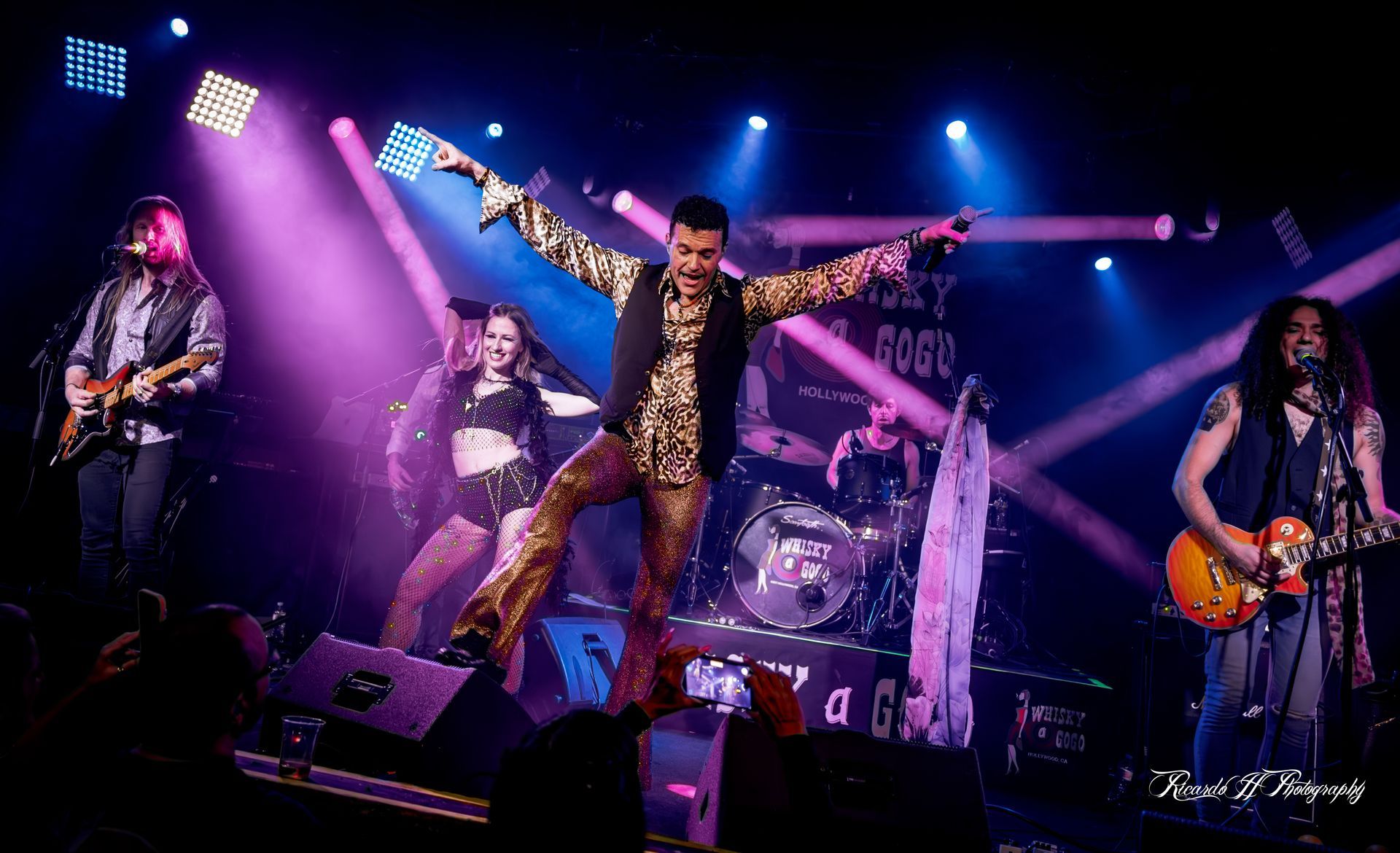 A group of people are playing instruments on a stage.