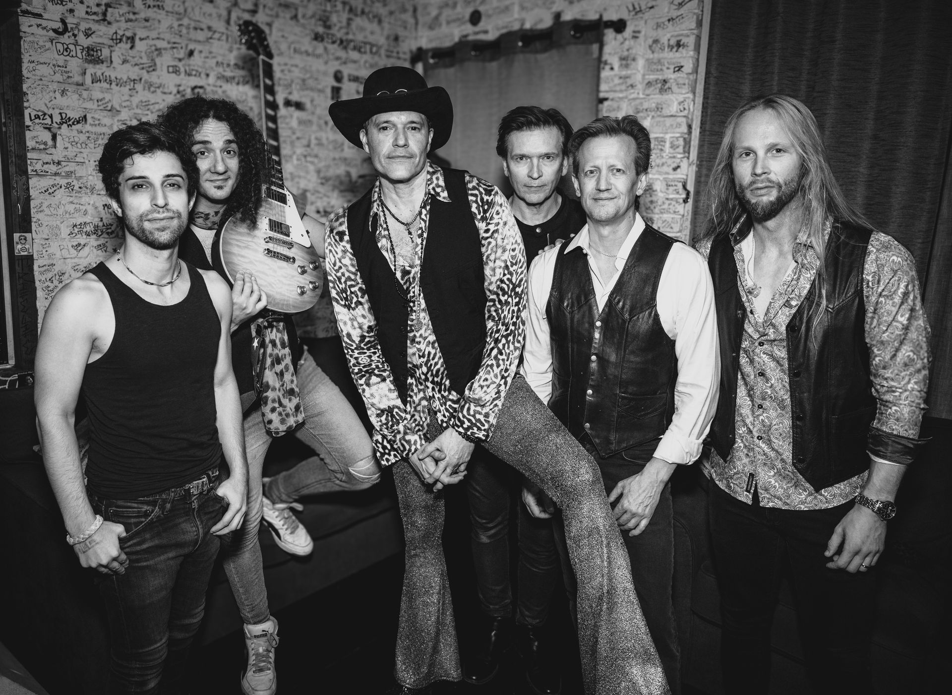 A black and white photo of a group of men posing for a picture.