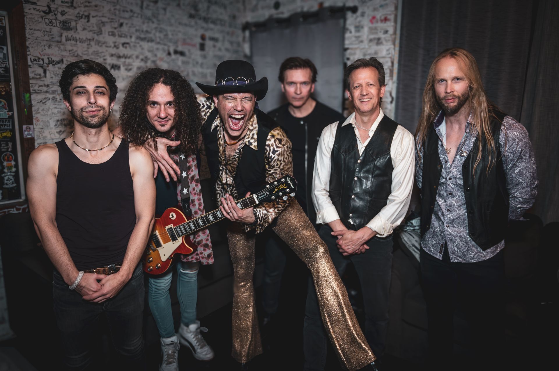 A group of men standing next to each other in a room.