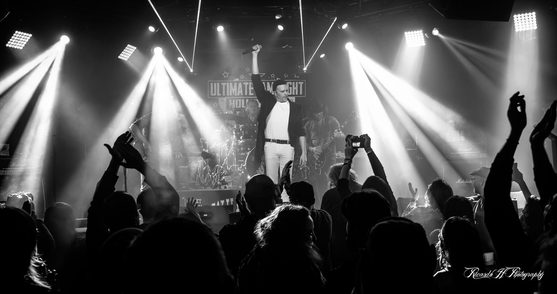 A black and white photo of a crowd of people at a concert.