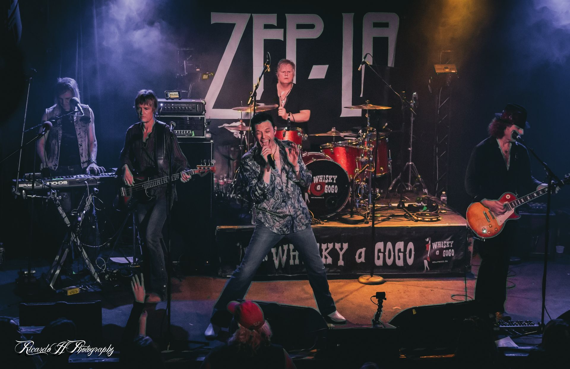 A group of people are playing instruments on a stage.