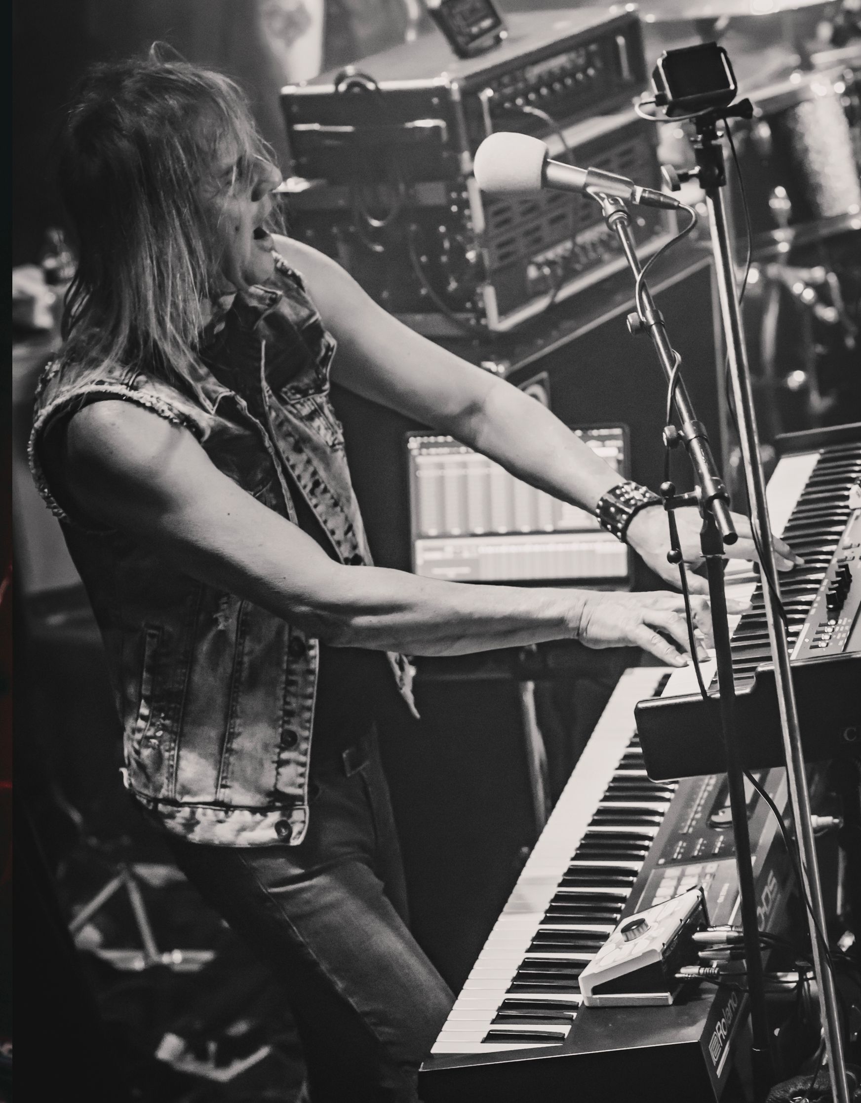 A black and white photo of a man playing a keyboard