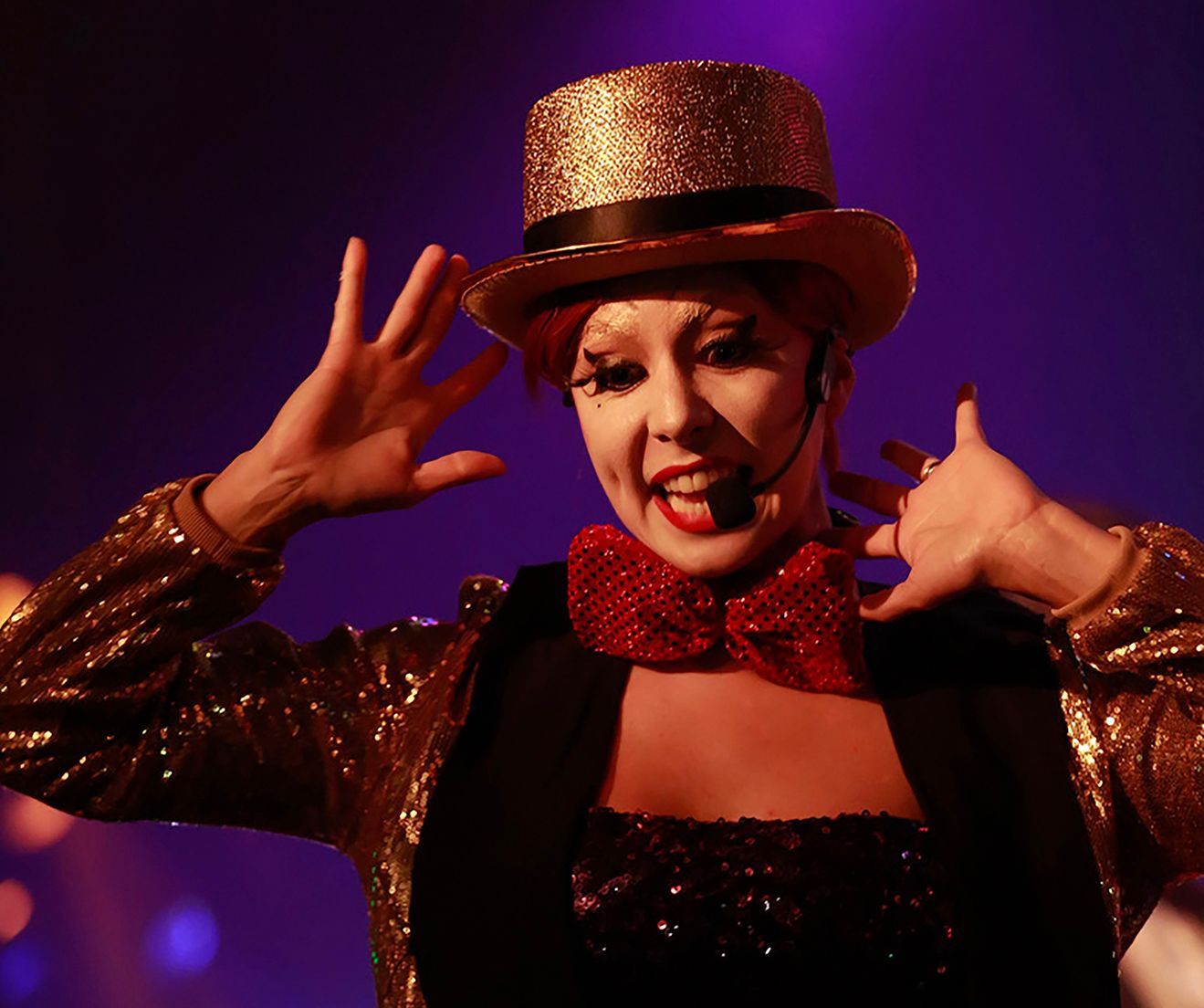 A woman is wearing a top hat and a bow tie