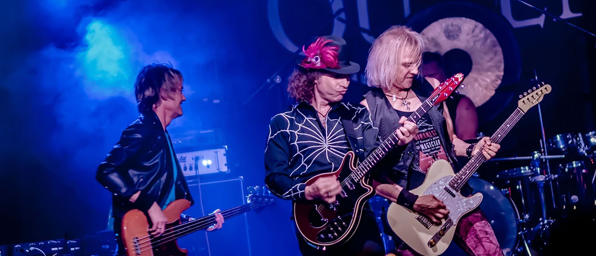 A group of people are playing guitars on a stage.