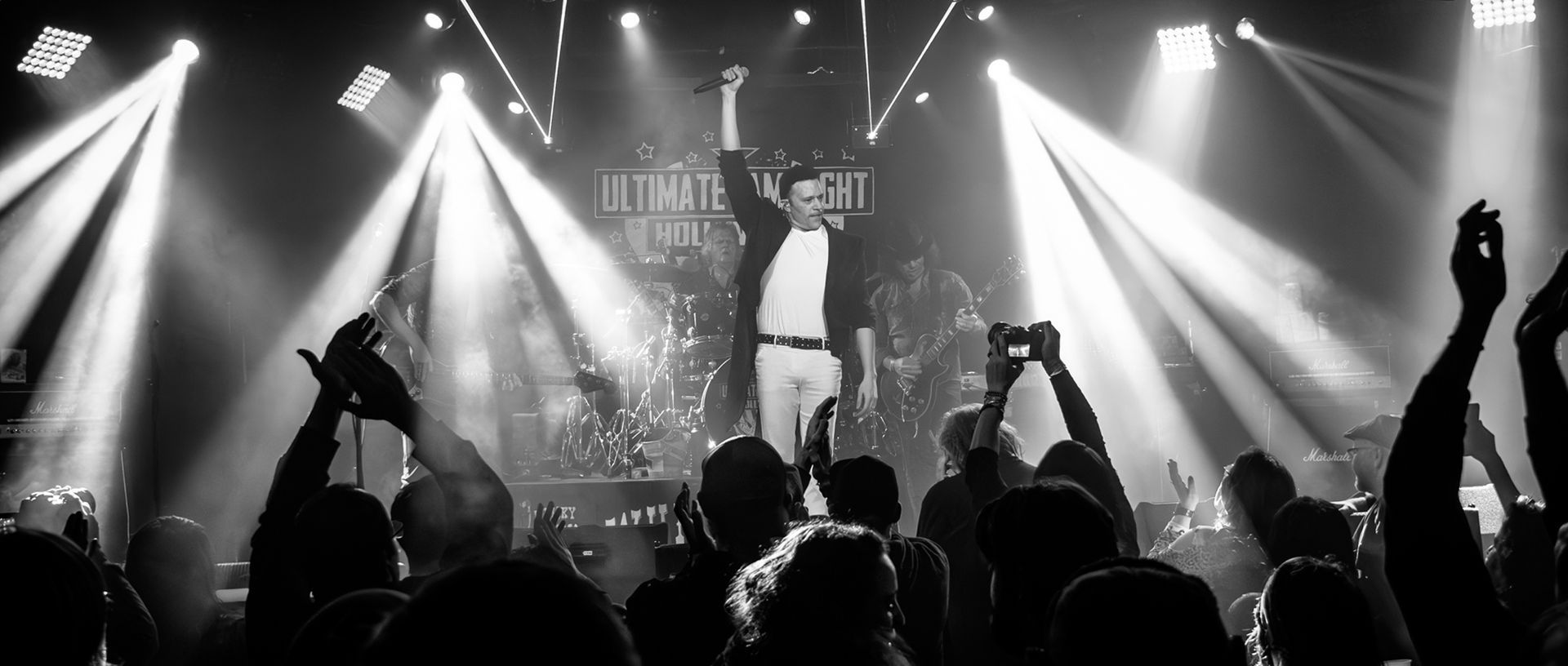 A black and white photo of a crowd of people at a concert.