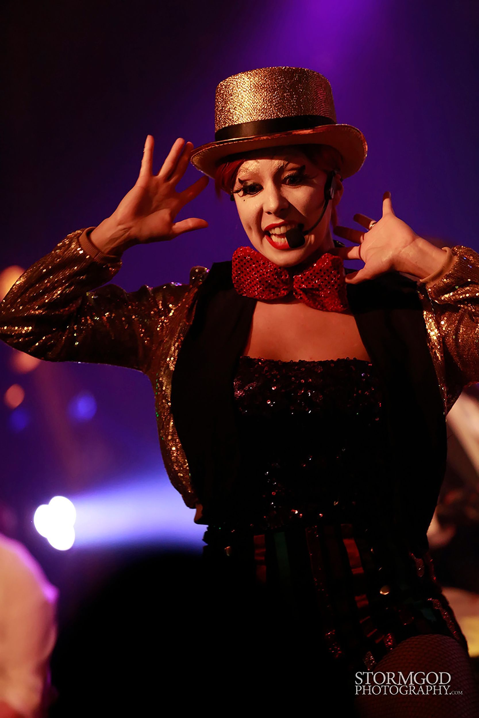 A woman is wearing a top hat and bow tie