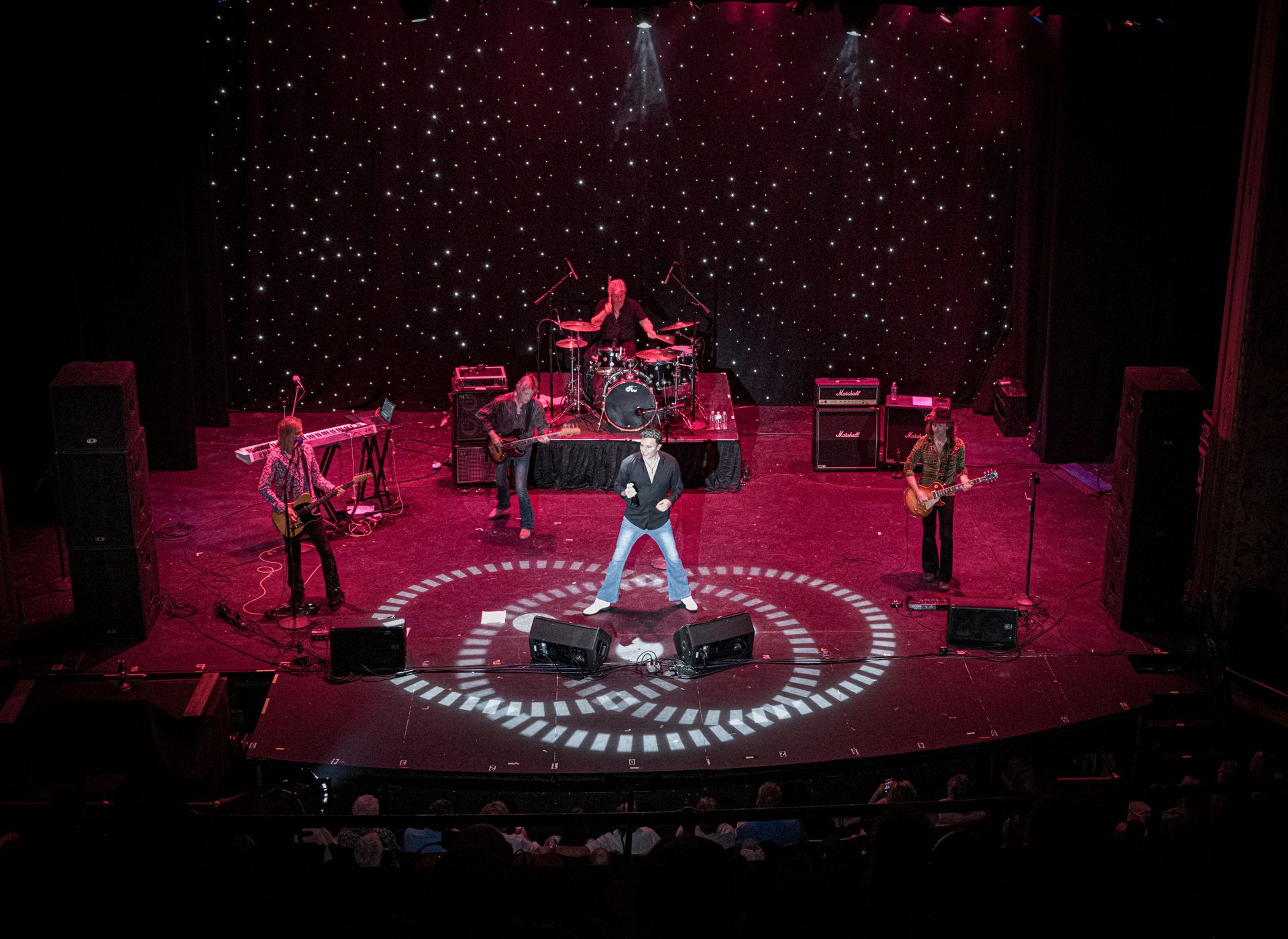 A group of people are playing instruments on a stage.